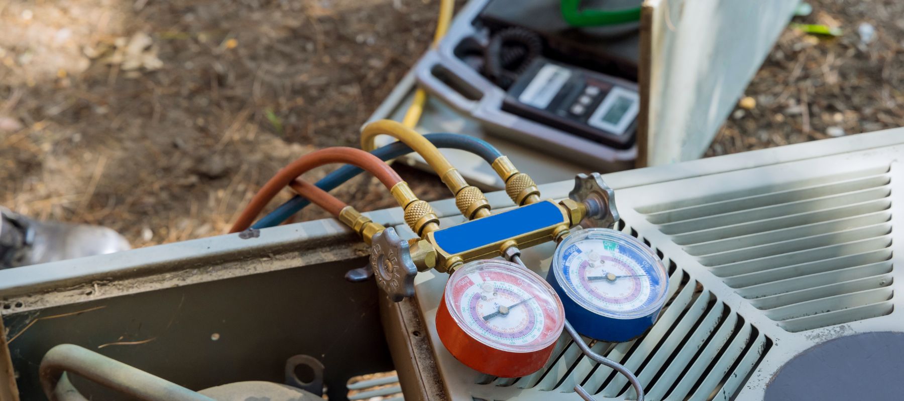 close up of gauges left hanging on a hvac unit