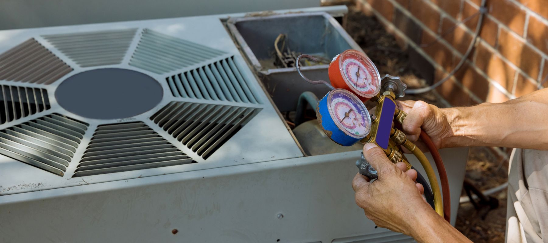 hhc tech inspecting his refrigerant gauges