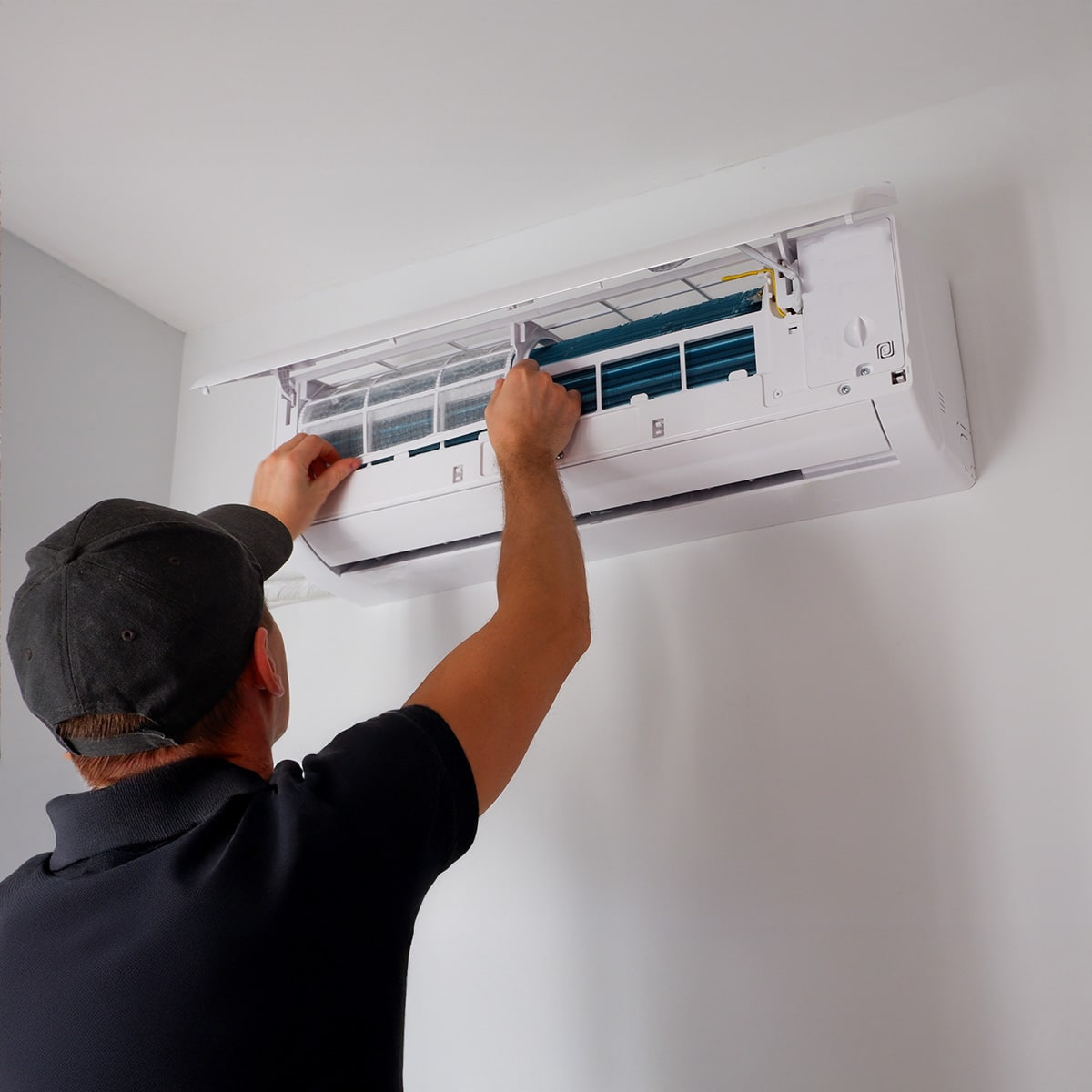 Honeycomb technician installing filter to a ductless AC