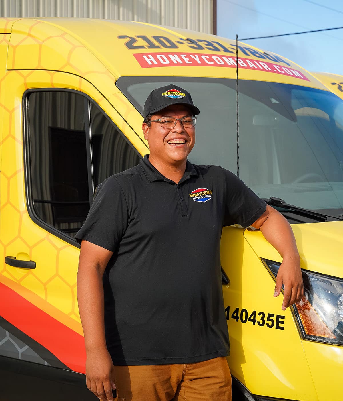 Portrait of a Honeycomb Heating and Cooling technician in front of a service van.