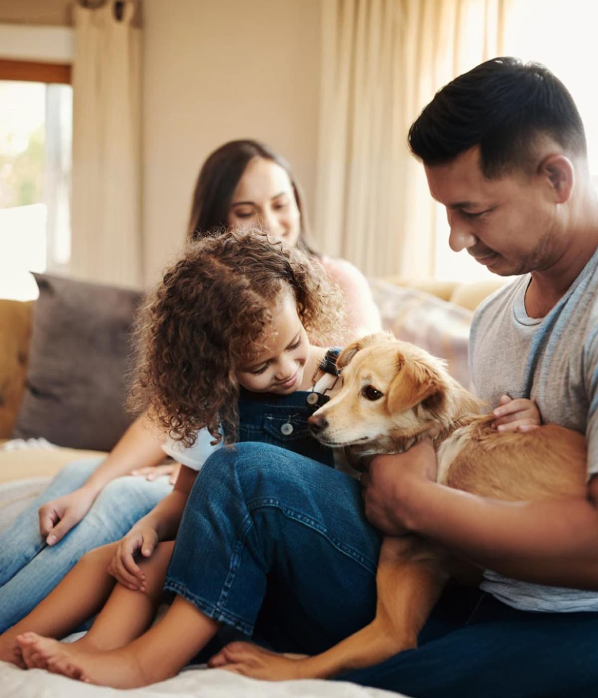 A joyful family spending quality time with their dog at home.