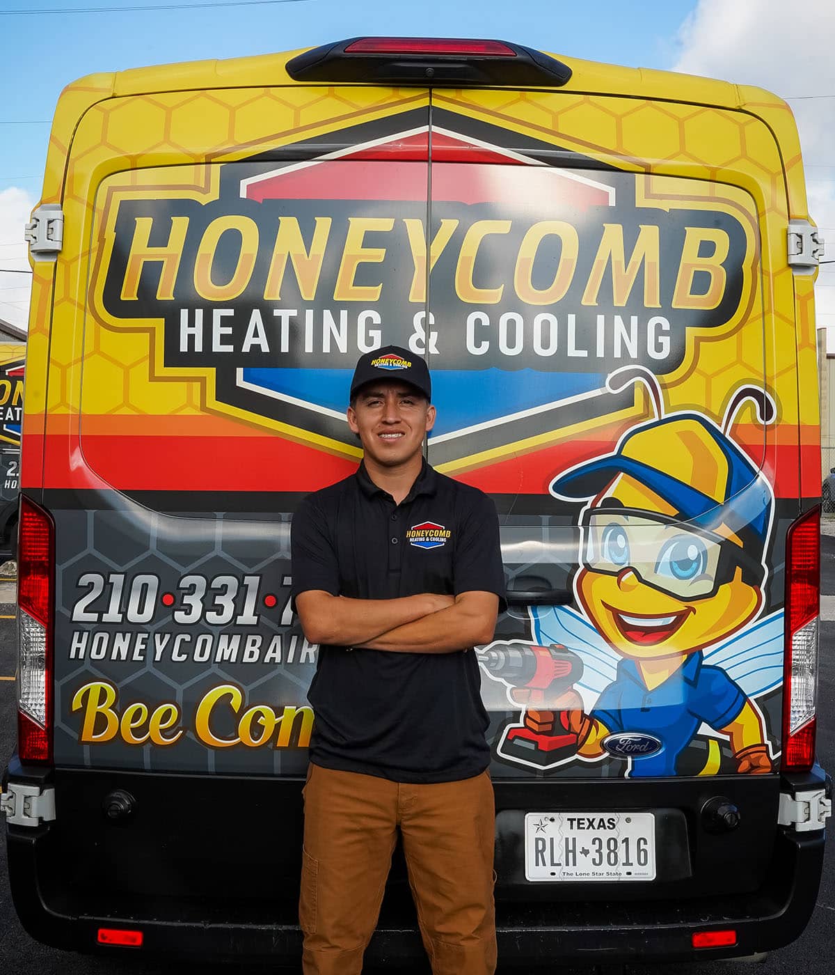 Portrait of a Honeycomb Heating and Cooling technician in front of a service van.