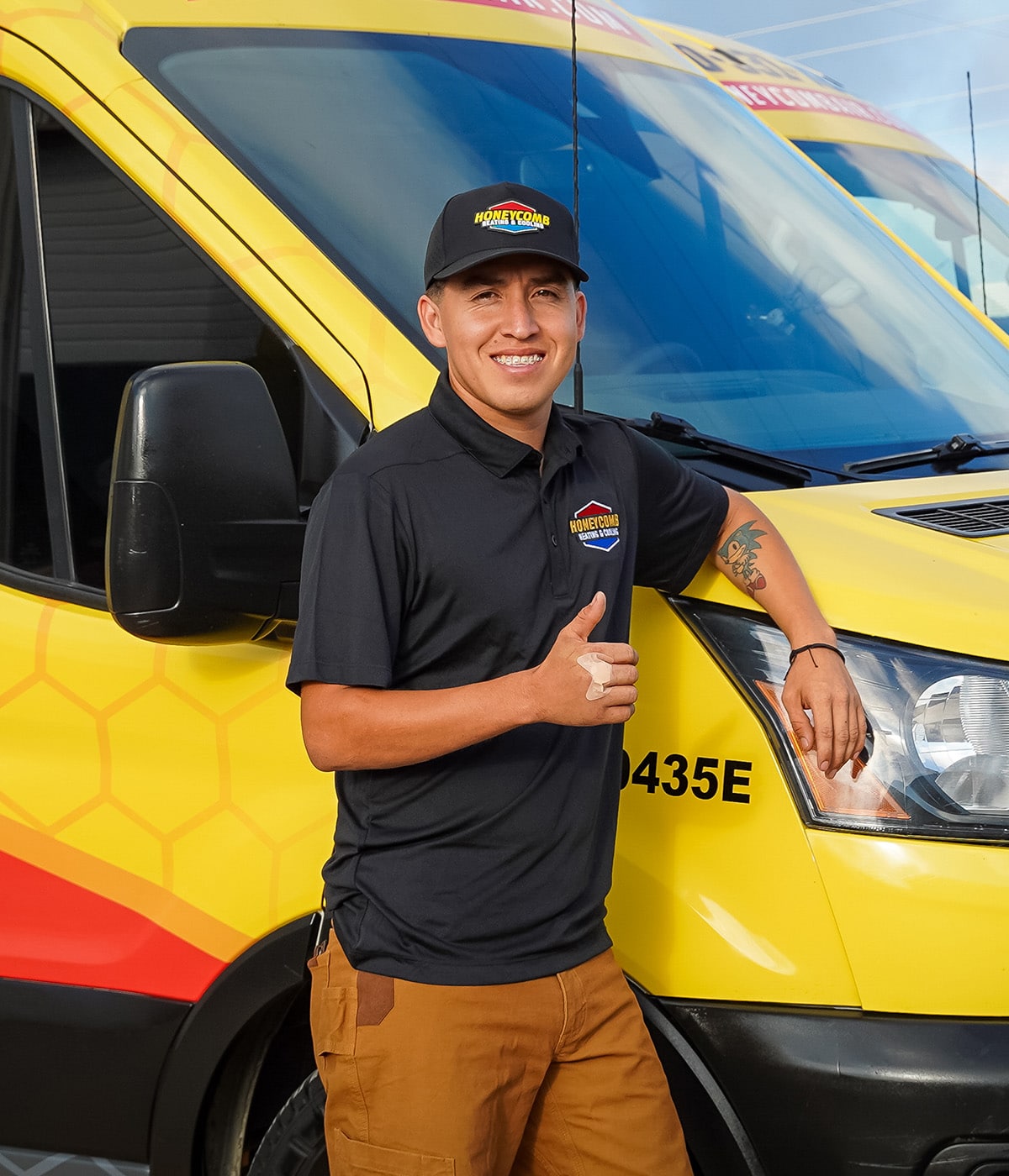 Portrait of a Honeycomb Heating and Cooling technician in front of a service van.