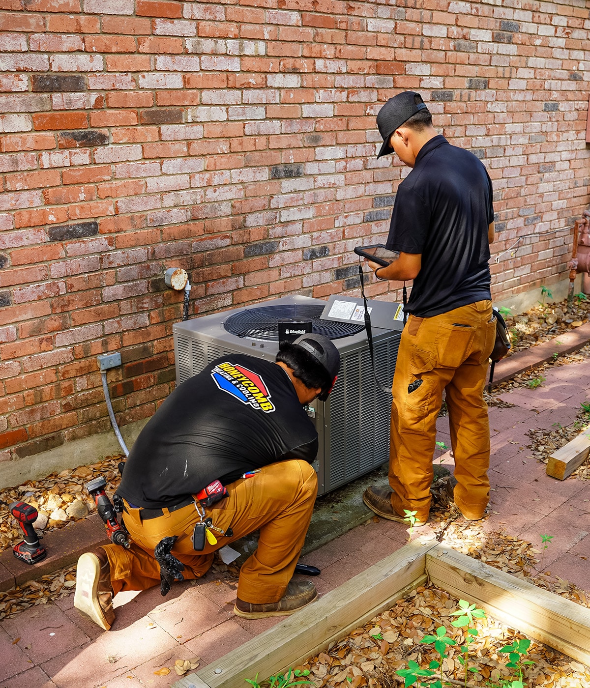 Honeycomb technicians repairing condenser