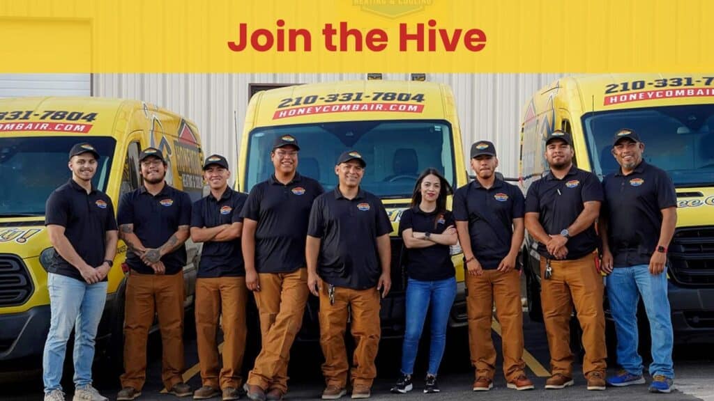 A group of Honeycomb Heating and Cooling technicians standing in front of yellow service vans for professional air conditioning maintenance.