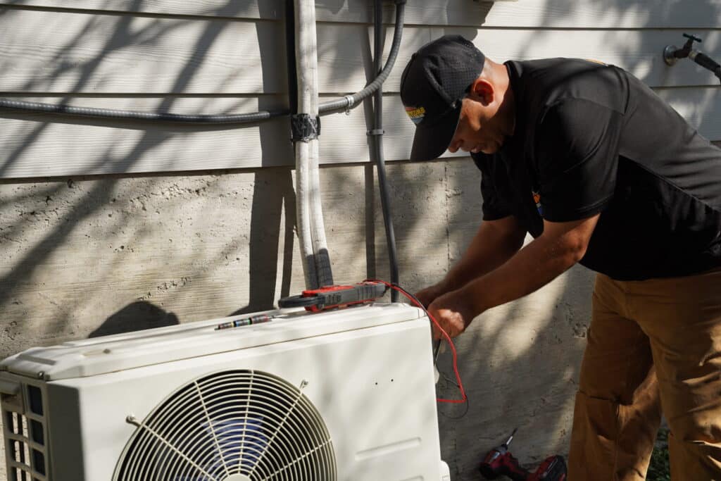 Professional Air Conditioning tune-up in Canyon Lake featuring electrical component testing on a Carrier condenser unit.-