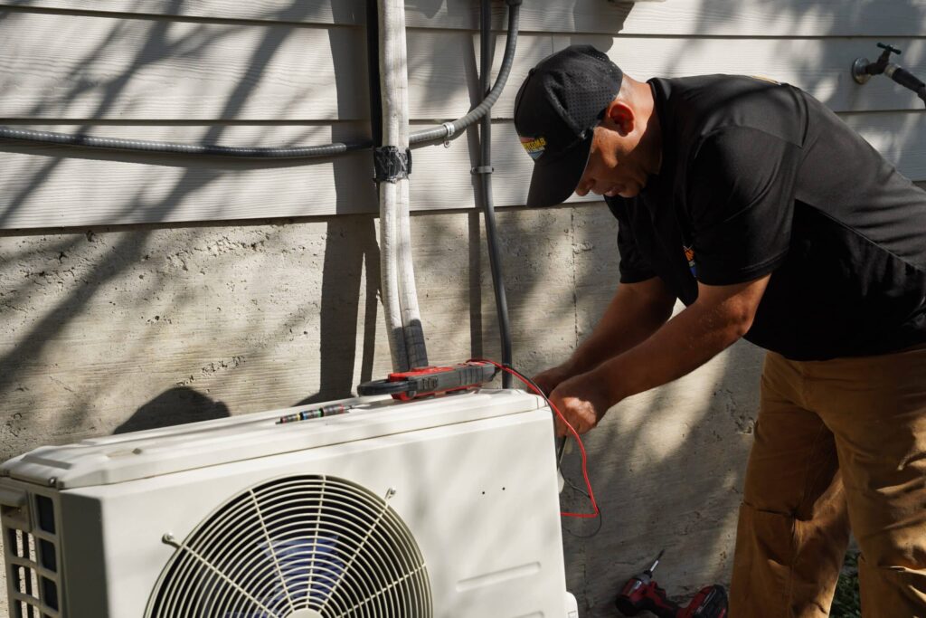 Professional Air Conditioning Castroville tune-up featuring electrical component testing on a Carrier condenser unit.