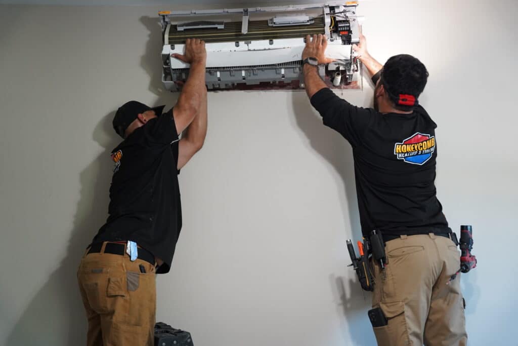 Honeycomb technician providing fast emergency AC repair on a residential system.