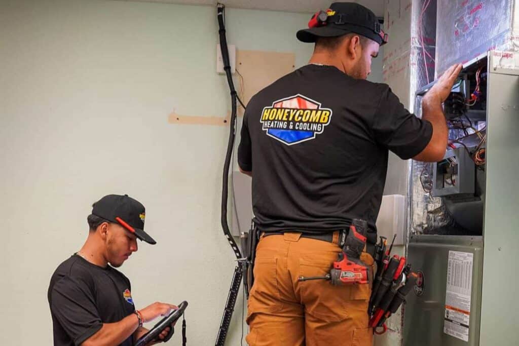 Honeycomb Heating & Cooling technician performing seasonal heater maintenance on a residential furnace system in Castle Hills.