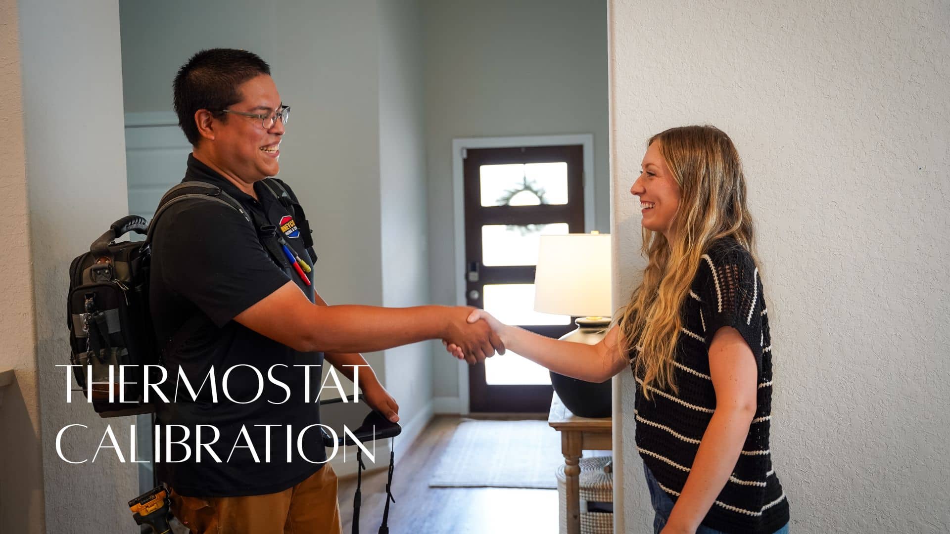 A Honeycomb HVAC technician shaking hands with a smiling homeowner inside her home, featuring a "THERMOSTAT CALIBRATION" text overlay.