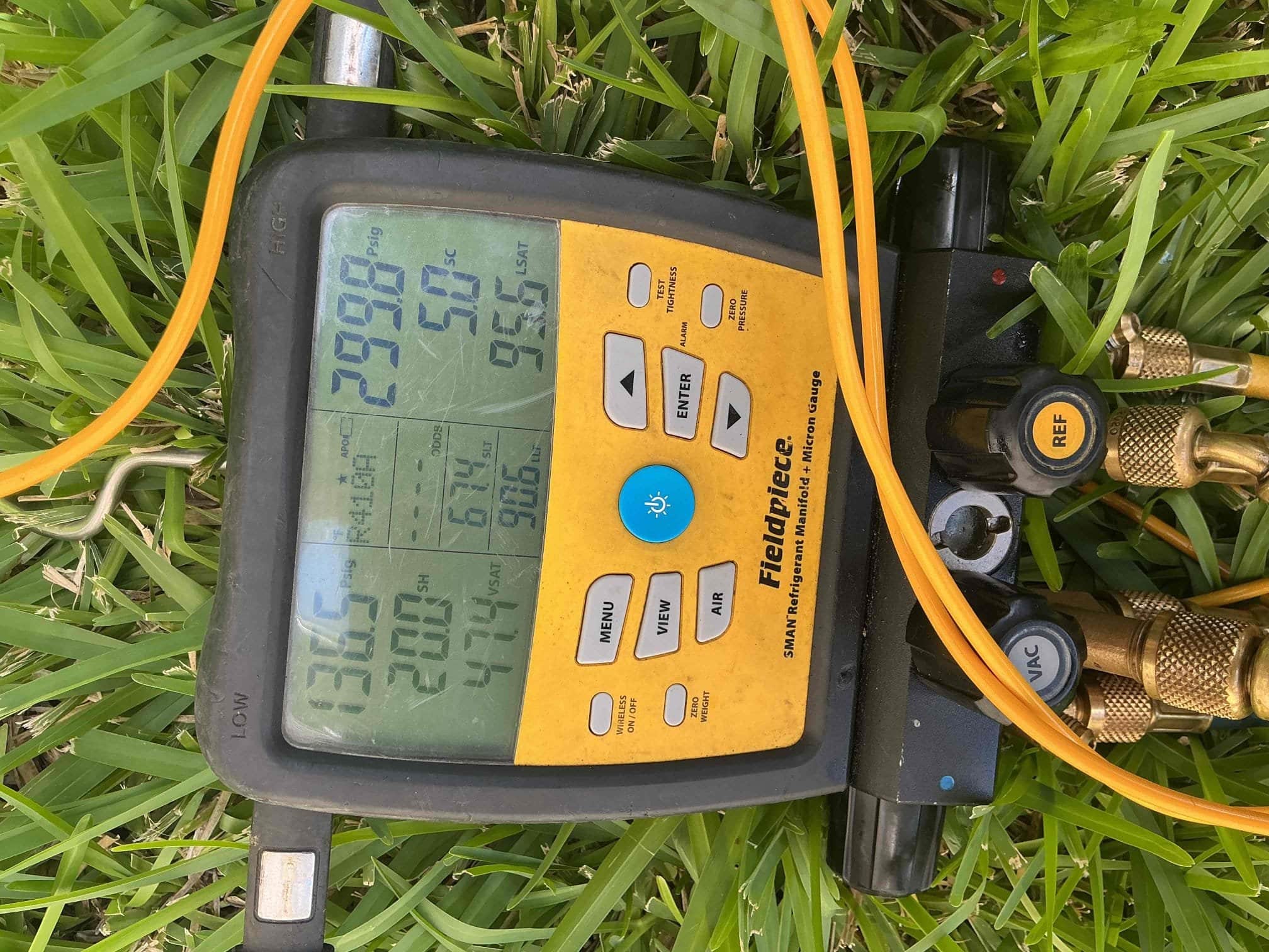 Professional HVAC technician performing AC Refrigerant Leak Repair and diagnostic testing in a San Antonio home