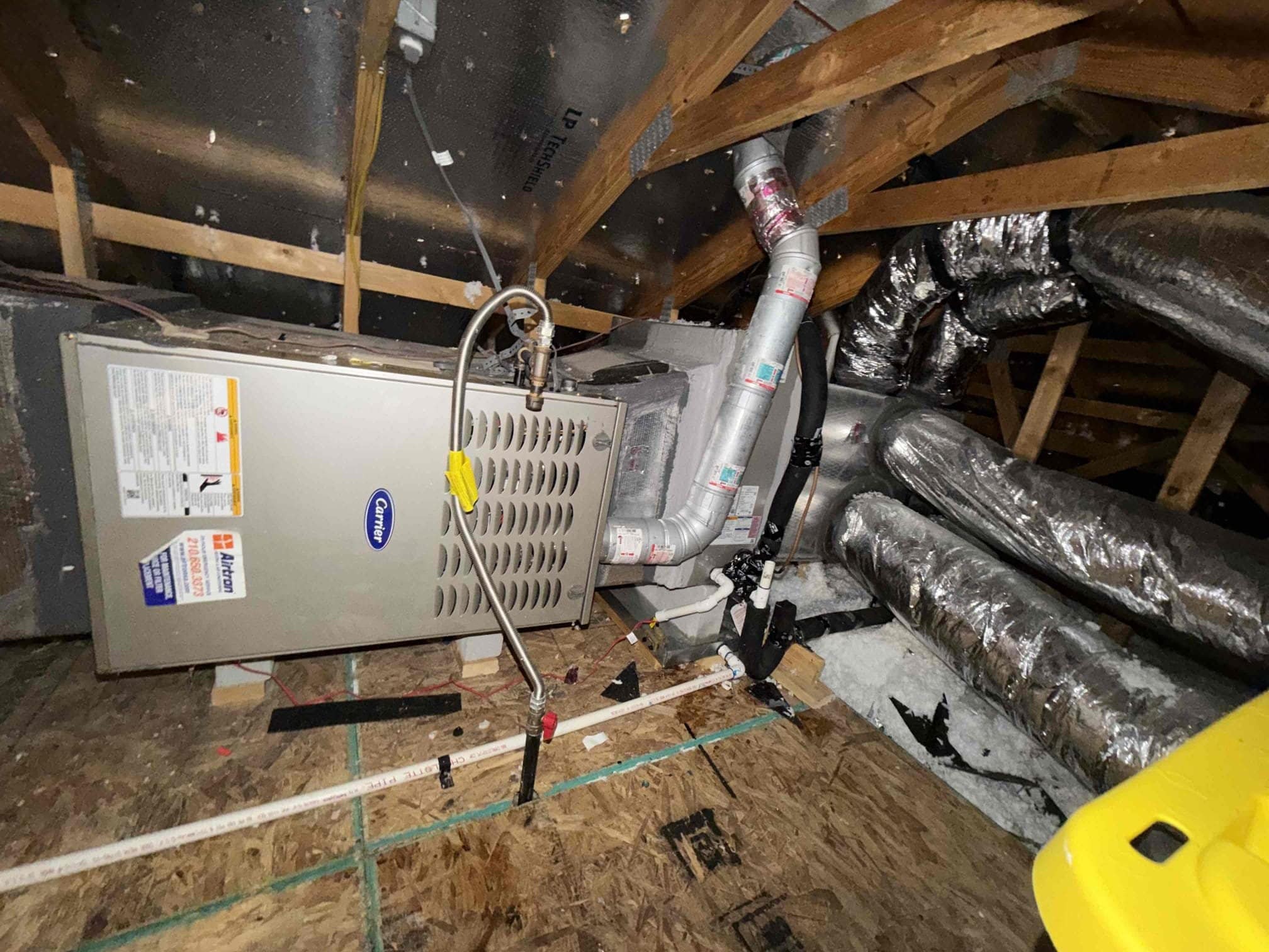 Professional HVAC technicians performing Ductwork Replacement and ventilation sealing in a San Antonio home attic