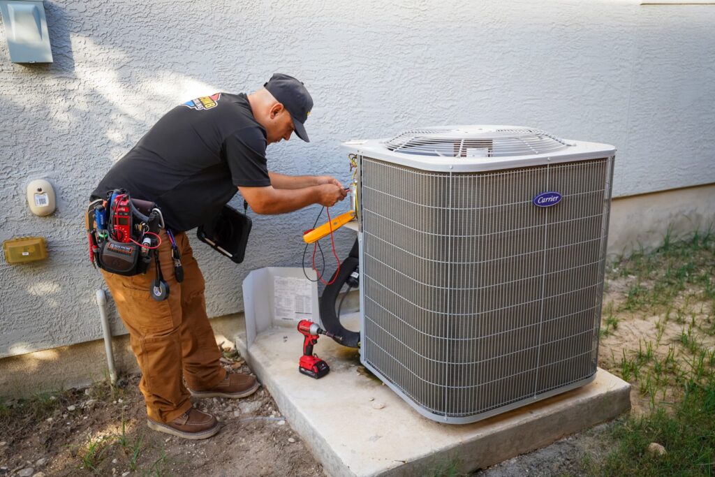 Professional HVAC technician performing a comprehensive AC tune-up and system inspection.
