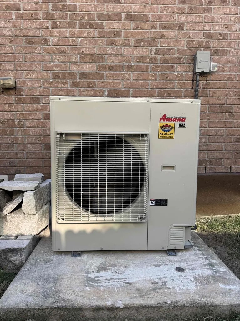 Installed Amana S-Series variable-speed inverter outdoor AC unit branded by Honeycomb Heating & Air Conditioning for a two-stage vs inverter ac San Antonio comparison.